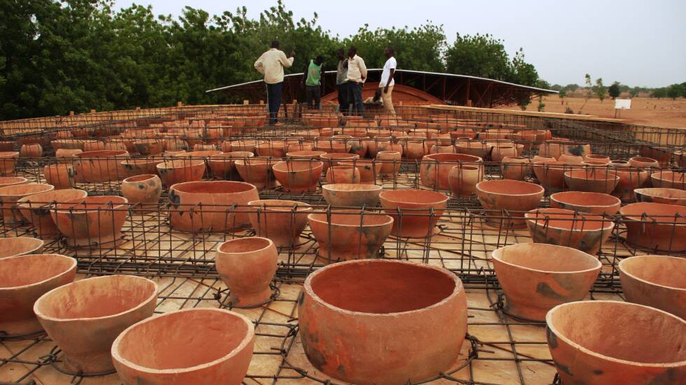 Construction Workers Installing Clay Pots On The Roof Of The Gando School Library Photo By Kr Architecture
